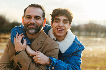 Happy father and son hugging in park