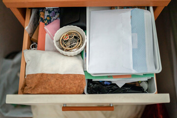 ugc of nightstand drawer open and full of things