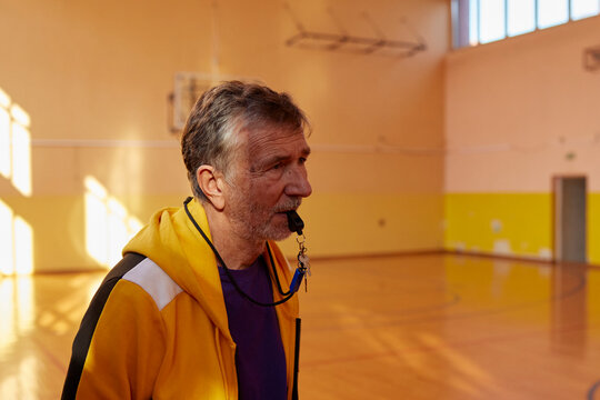 Portrait of a coach holding a whistle in his mouth