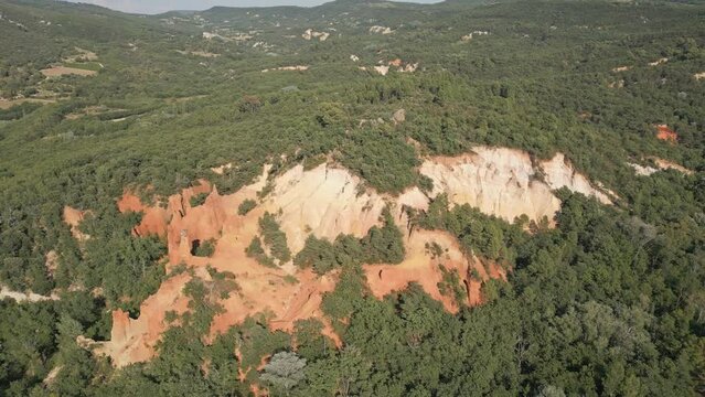 Aerial footage of Red sands and abstract Rustrel canyon moher cliffs landscape. Provencal Colorado near Roussillon,in the Vaucluse department - Southern France.