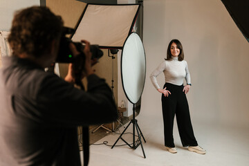 Cheerful woman posing for photo shoot in studio