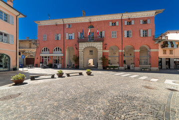 Fototapeta na wymiar Chiusa di Peso, Cuneo, Italy - April 19, 2024: The town hall seen from via Roma on clear blue sky