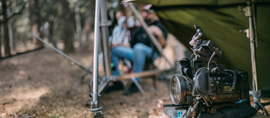 Professional film and video camera on the set. Shooting shift, equipment and group. Modern...