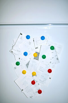 Receipts on magnets on the refrigerator
