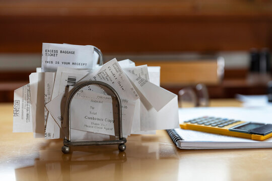 home office Receipts in paper holder rack with calculator