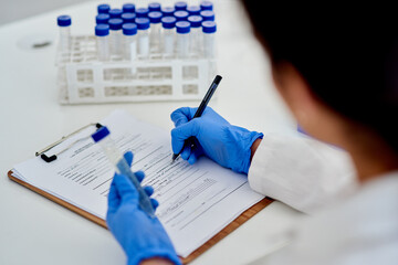 Scientist, clipboard and lab results with test tube, medic and microbiologist or research for...