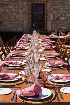 A decorated wooden wedding table filled with glass wine