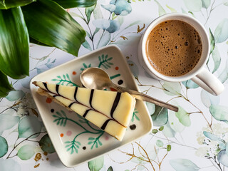 Cup with black coffee and tasty cake with cream on the table