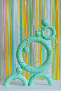 Green colored torus with with sparkles, beads on a coloured background