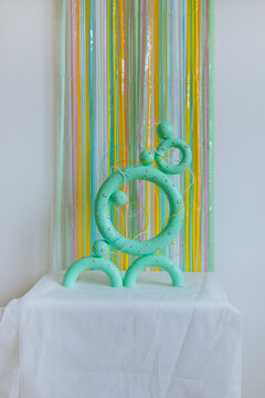 Green colored torus with with sparkles, beads on a coloured background