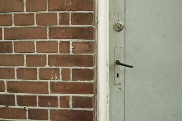 Brick wall, door and building in urban area for design, texture and architecture for construction. Concrete, pattern and vintage structure for development, exterior and maintenance in old town.