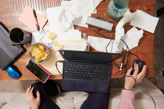 Overhead viewpoint of Asian Business Woman With Messy Receipt Pile 