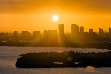 Aerial view of downtown district of Tampa city in Florida, USA at sunset. Dark silhouette of high...