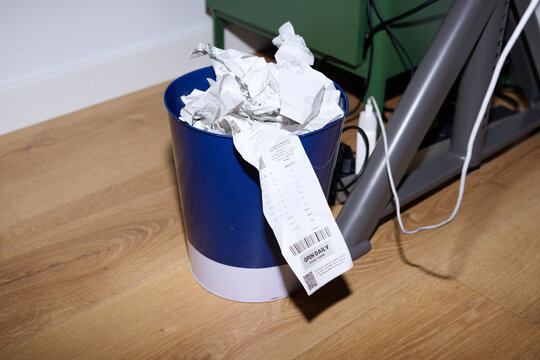 Discarded Receipts in Trash Bin