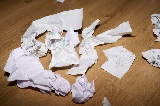 Crumpled Receipts on Wooden Floor - Powered by Adobe