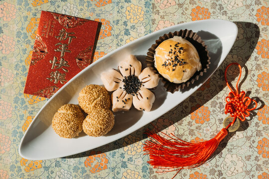 Chinese Pastries with Red Envelope and Lucky Knot for Lunar New Year