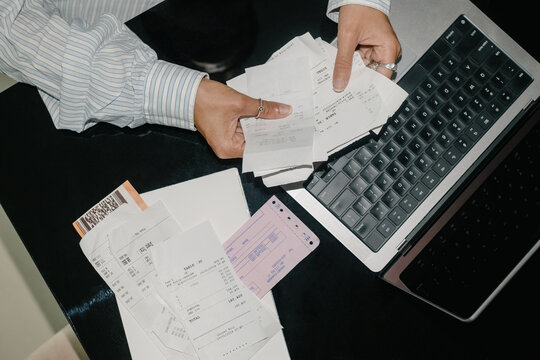 Close-Up of a Woman Sorting Through Paperwork at Her Home Office Desk