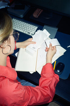 Focused Female office employee working on manages receipts, invoices
