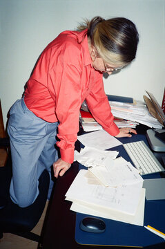 Focused Female office employee working on manages receipts, invoices