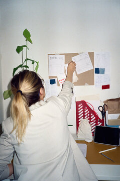 Unrecognizable woman examining papers in office