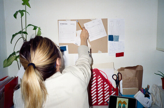 Unrecognizable woman taking notes on clipboard