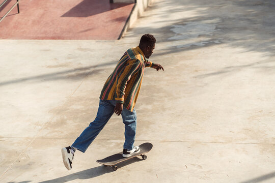 Active black man skateboarding