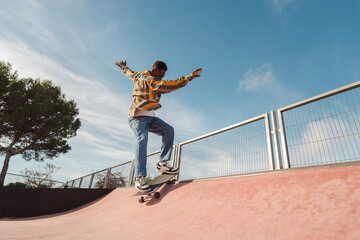Active black man skateboarding on a ramp