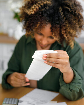 Top view person counts the receipts.