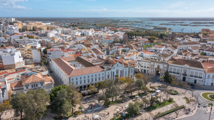 Traditional Portuguese town of Faro with old architecture, filmed by drone. Arco de villa and largo...