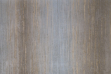 Gray, blue, brown and golden textured wall surface. Rough stylized texture. Abstract decorative background. Old effect background for wallpaper or graphic design.