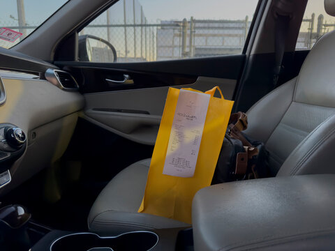 Receipt for take out food in bag of delivery vehicle 