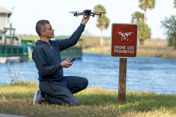 Man is going to fly his quadcopter in no drone area. Operator unlawfully using his UAS in state park near restriction sign