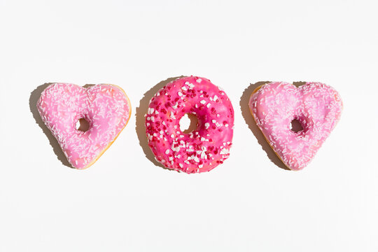 Heart-shaped donuts with pink icing. Valentine's day. 