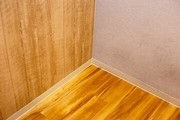 Wooden floor and wall with skirting boards