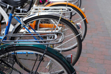 Fototapeta na wymiar A group of bicycles lined up in a row on the sidewalk.