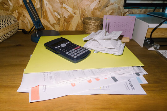A folder full of files, invoices, and receipts