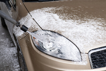Washing the car with active foam. Spraying the car with foam.