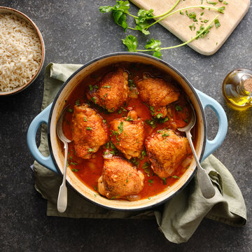Braised chicken thighs cooked in  spicy tomato sauce.