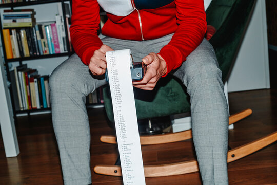 man doing different calculations in an electronic calculator