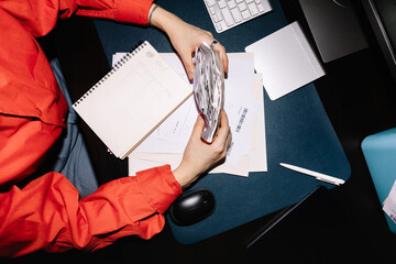 Crop faceless woman manages a stack of receipts in office