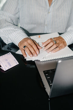Close-Up of a Woman Sorting Through Paperwork at Her Home Office Desk