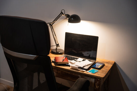 Desk With Receipts, Credit Cards, Notebook And Computer.