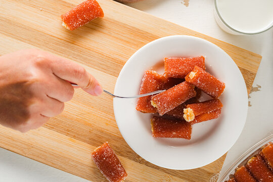 Person eating guava rolls