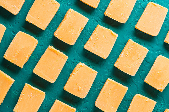 Dulce de leche squares on a concrete background