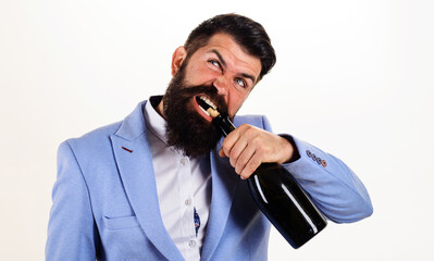 Bearded man in suit trying to open wine bottle with teeth. Brutal handsome man opens his teeth...