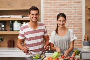 Cooking, portrait and happy couple in kitchen for healthy food or vegetables for lunch or dinner. Smile, people and romantic woman in meal prep for salad preparation or hungry vegan man in home