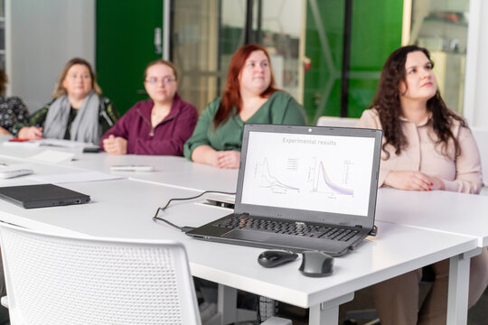 People Listening To The Scientific Presentation 