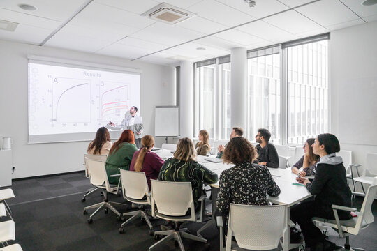 Man Performing PhD Thesis Defence To Audience