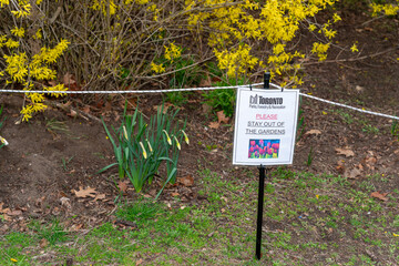 Fototapeta premium City of Toronto Parks Forests and Recreation sign pleading with park visitors to stay out of garden