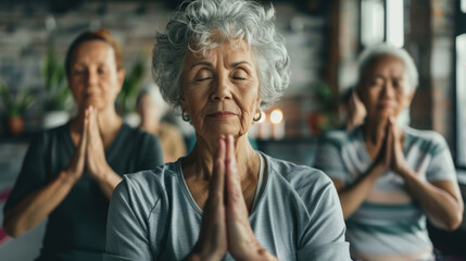 A group of elderly women are participating in a yoga session together, performing various poses and stretches in a studio setting - Powered by Adobe